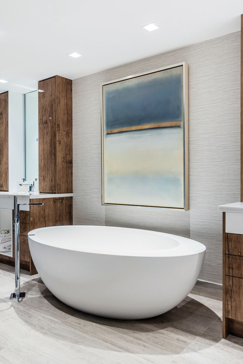 Resurrecting the dark and light juxtaposition, the luxurious master bath features MTI’s white Cascara freestanding deep-soak tub surrounded in neutral tones further warmed by rich wood finishes.