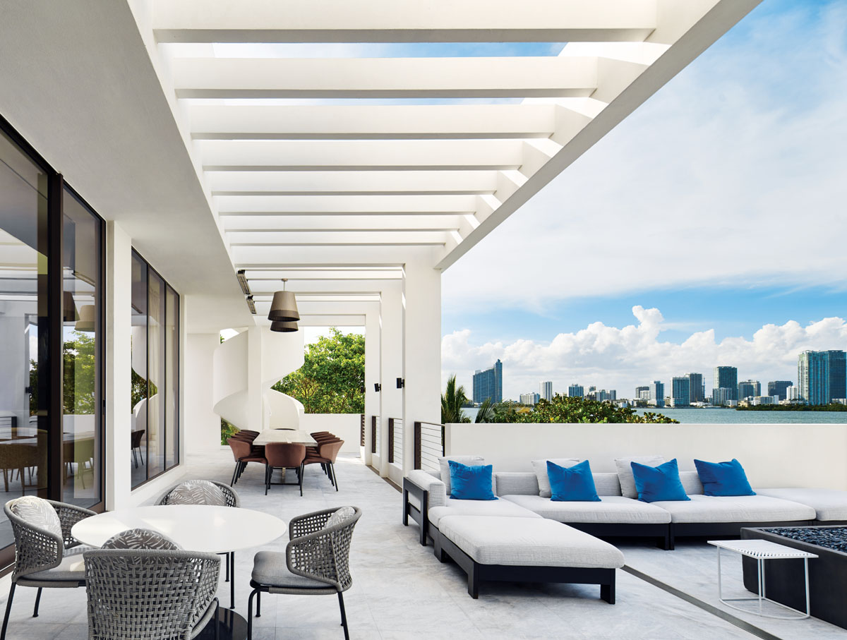 Scenes of the Miami skyline and the Biscayne Bay shoreline are the raisons d’etre for a dramatic floorplan reversal that sites a balcony on the upper level of this San Marco Island home. With an array of Minotti outdoor furnishings and an E.M. Soberon dining table, the homeowner sought a palette to echo the lush tropical setting.