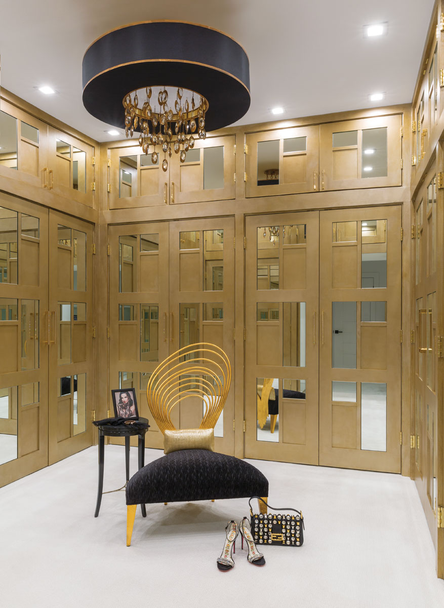 In the master dressing room, Bergmann dreamed up a closet system from standard three-paneled TruStile bifold doors, flat-stock applied molding, cut mirror, and champagne metallic paint. An oversized John Richards chandelier illuminates this dream closet.