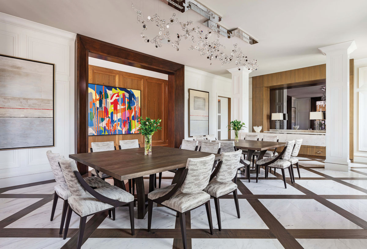The main dining room is a versatile space where the dining room tables can be pushed together to accommodate the extended family or pulled apart for more intimate meals. Between the two columns is a stone buffet often used as a serving area during dinner parties.