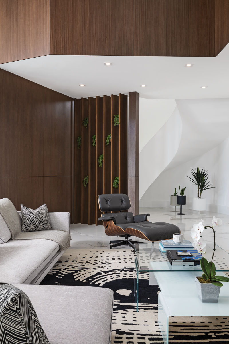 The iconic black Eames lounge chair and ottoman was a gift from Gomes to her husband, who is also a design lover. The black-and-white area rug was chosen for its unusual design.