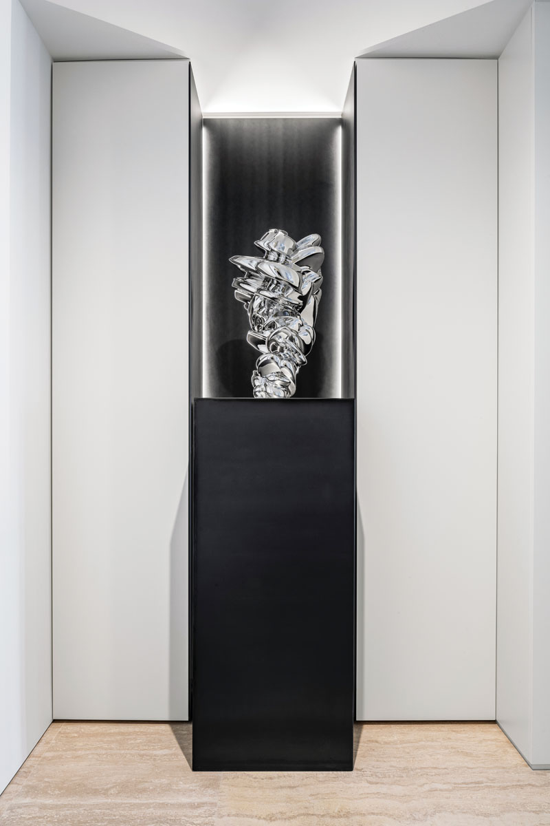 In the elevator foyer, two white lacquer closets frame Tony Cragg’s Seam, a stainless steel sculpture inside a custom LED-illuminated steel pedestal.
