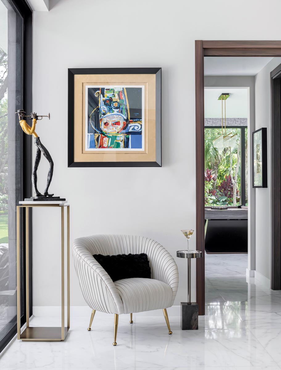 The media lounge incorporates Interlude Home’s white leather chair counterbalanced with the expressive pose of a trumpet player sculpture by the late artist and former NFL player George Nock. An abstract piece by artist and scholar David Driskell adds a vibrant accent.