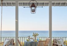 Blissfully serene, the terrace of this Rosemary Beach getaway captures postcard vistas of the Emerald Coast. The gulf-front property underwent a top-to-bottom refresh by Montgomery interior designer Ashley Gilbreath. Lounge chairs from Summer Classics and a lantern from Legendary Lighting complement the quaint aesthetic.