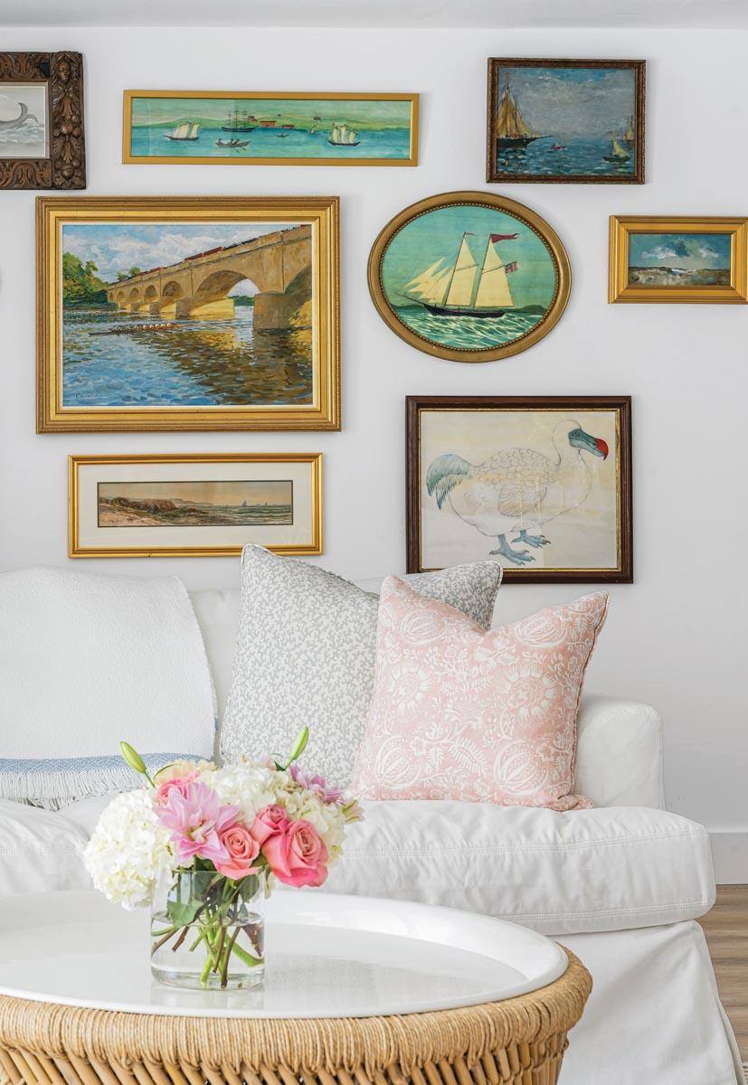 Across from the kitchen, a seating area features a gallery wall comprised of family heirloom artworks and pieces purchased at local antique shops and vintage marketplaces.