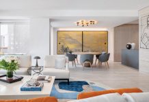 This residence on Fisher Island opens onto a bright central living area delineated by a dining space punctuated with a rare Japanese panel by Mori Tetsuzan from the Edo period. A sleek Henry Timi dining table and Glynell chairs by Elliott Barnes bask in the glow of a striking alabaster and brass lighting fixture by Apparatus Studio. Photo © Oliver Jaist
