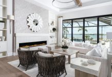 A tone-on-tone palette of cream, white, and beige defines the design approach in the living room, yet the roped structure of the custom chairs warms up the space with organic color. Designer Carrie Riley’s goal with the window treatments was to frame the outdoors: “When you look through the room, the curtains look like two pigtails on either side.”