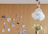 “We wanted to play with wood tones in the living room,” says Mascarenhas. The Gather table by dk3 and Wishbone chair by Carl Hansen & Søn were sourced from Design Within Reach. The Knotty Bubbles Chain chandelier by Lindsey Adelman illustrates Mascarenhas’ idea of the residence as a beach cabin. A collage of ceramics on the back wall alludes to pastoral themes.