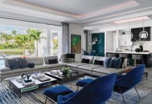 The great room prioritizes sweeping panoramic views of the native landscape along with the property’s water features. Centered beneath a floating reversed-soffit ceiling feature, Roche Bobois’ ultra-modern furnishings generate a chic French vibe.
