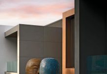 Poised in complementary hues, artist Jun Kaneko’s ceramic heads appear to float atop a reflecting pool ensconcing the home’s front exterior façade. The sculptures bring a fluid organic shape to the sleek linear design.