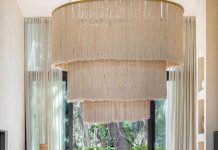 Traditional to Mexican design, the fringed lighting fixture by Neutro Home in the living room is made with henequén, a type of sisal that’s durable and weather-resistant. The sofa grouping and cocktail table are from Rove Concepts.
