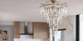 “Our design throughout the apartment is very linear and that’s why we chose this square table by Hellman Chang for the dining area,” says designer Zita Rudd. “The Aqua Funnel chandelier by Serip offers just the right amount of glamour.” The bleached walnut on the kitchen cabinetry was the wood used throughout all the common spaces.