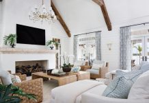 Breezy Island Charm and Sophistication Abound in Siesta Key Retreat The living room’s ceiling wood beams are reclaimed from old Ohio barns. The soaring, 72-inch-wide fireplace is paired with a hand-carved coral mantle. Furniture here includes lounge chairs by Palecek, draperies by Quadrille, and an area rug by Stark. The coffee tables are from the homeowners’ previous residence.