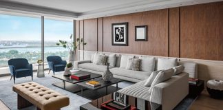 The living room’s rich, plush velvets and warm woods evoke cosmopolitan finesse. Signature works by Miró and Picasso blend with a sculptural vase from Mindy Solomon Gallery. Dan Benchetrit of Opera Gallery in Miami curated the hanging artworks throughout the residence, with input from the homeowners and designer Tamara Feldman.