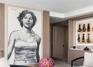 The transition from the entry to the main living area provides a perfect place to display some of the homeowners’ collection of Latin art and photography, including a charcoal portrait by Javier Guerra Fernandez and a colorful sphere sculpture by David Leonardo.