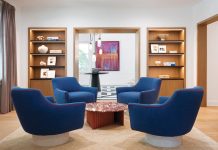 A chic conversation cluster in the sitting room centers around a red marble cocktail table by Antoni Pallejà for RS Barcelona, surrounded by cobalt blue swivel chairs with fuchsia welting by Jhon Ortiz for Tailored Hom