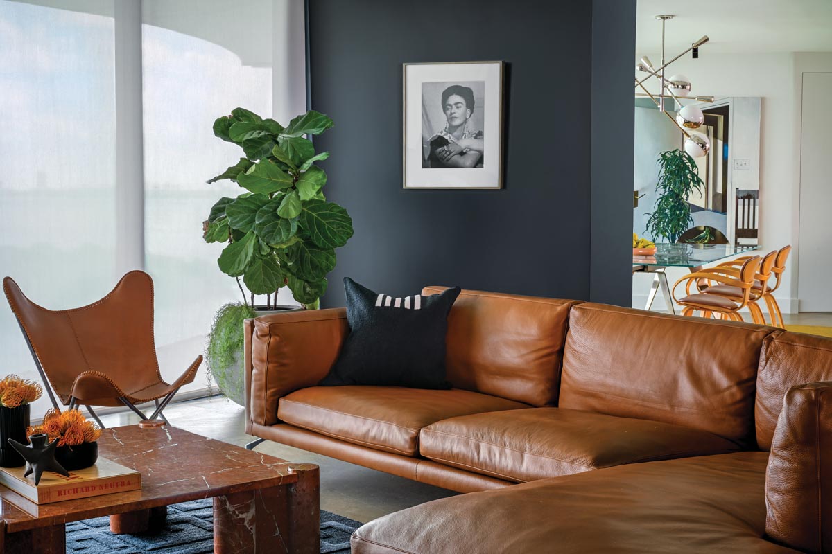 A rust-colored leather Como sectional sofa from Design Within Reach and a black Fendi Casa rug give the den/media room a relaxed air of sophistication, along with Manhattan Home Design&rsquo;s Poggio square marble coffee table. On the wall, an original 1940 Bernard Silberstein photograph of artist Frida Kahlo commands the space.