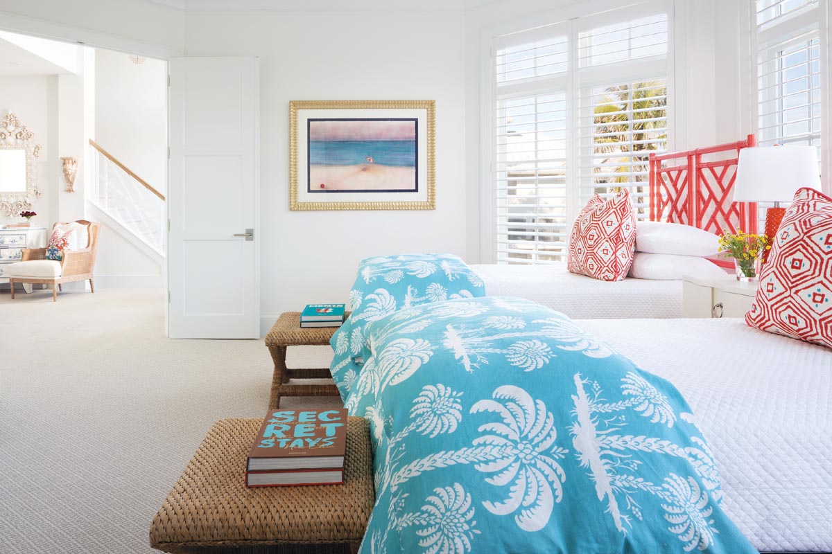 In the &ldquo;coral guest bedroom,&rdquo; so named because in the pre-renovated house the walls were painted coral, the homeowners agreed that it was time for a more subtle take on the color. Throw pillows in a fabric by Thibaut and lacquered headboards by David Francis shine in the signature coral, while turquoise bed linens provide a refreshing contrast.