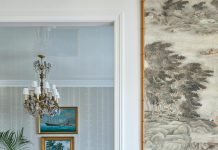 A well-balanced mélange of old and new continues in the dining room, refreshed with a Waterhouse Pavilion Stripe wallcovering from John Rosselli & Associates. The room is anchored by a textural seagrass area rug from Rush House.