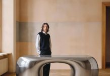 Designer Paddy Pike with the Arnardo desk, handcrafted in Spain