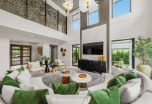 “We designed the living room as an elegant, open gathering space,” says Young. “The pops of green on the cushions reflect the landscape outside.”