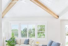 The design of the living room was about fashioning a space that’s both relaxed and refined. “The ceiling details and beams add architectural warmth,” says Moss, “while the blue accent chairs bring in a subtle coastal nod without feeling overly themed.” To soften the room, rounded forms were incorporated wherever possible.