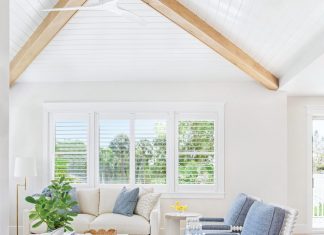 The design of the living room was about fashioning a space that’s both relaxed and refined. “The ceiling details and beams add architectural warmth,” says Moss, “while the blue accent chairs bring in a subtle coastal nod without feeling overly themed.” To soften the room, rounded forms were incorporated wherever possible.