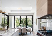 The design team envisioned the indoor dining space as an informal extension of the kitchen. Gold-toned pendants and chandeliers throughout the main living area provide visual continuity while still giving each functional area its own look.