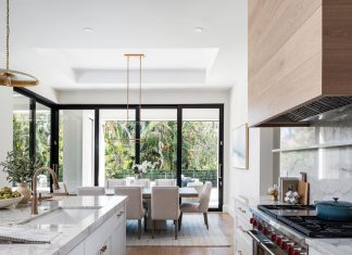 The design team envisioned the indoor dining space as an informal extension of the kitchen. Gold-toned pendants and chandeliers throughout the main living area provide visual continuity while still giving each functional area its own look.