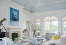 Coastal Charisma Inside a North Palm Beach Home “The living room is airy and spacious with soaring ceilings and spectacular waterfront views,” says Canet. “The decoration here started with an antique Swedish carpet from Doris Leslie Blau. The grand bird and leaf design chandelier from Apsara lends an organic feel and leads the eye up to the ceiling.”
