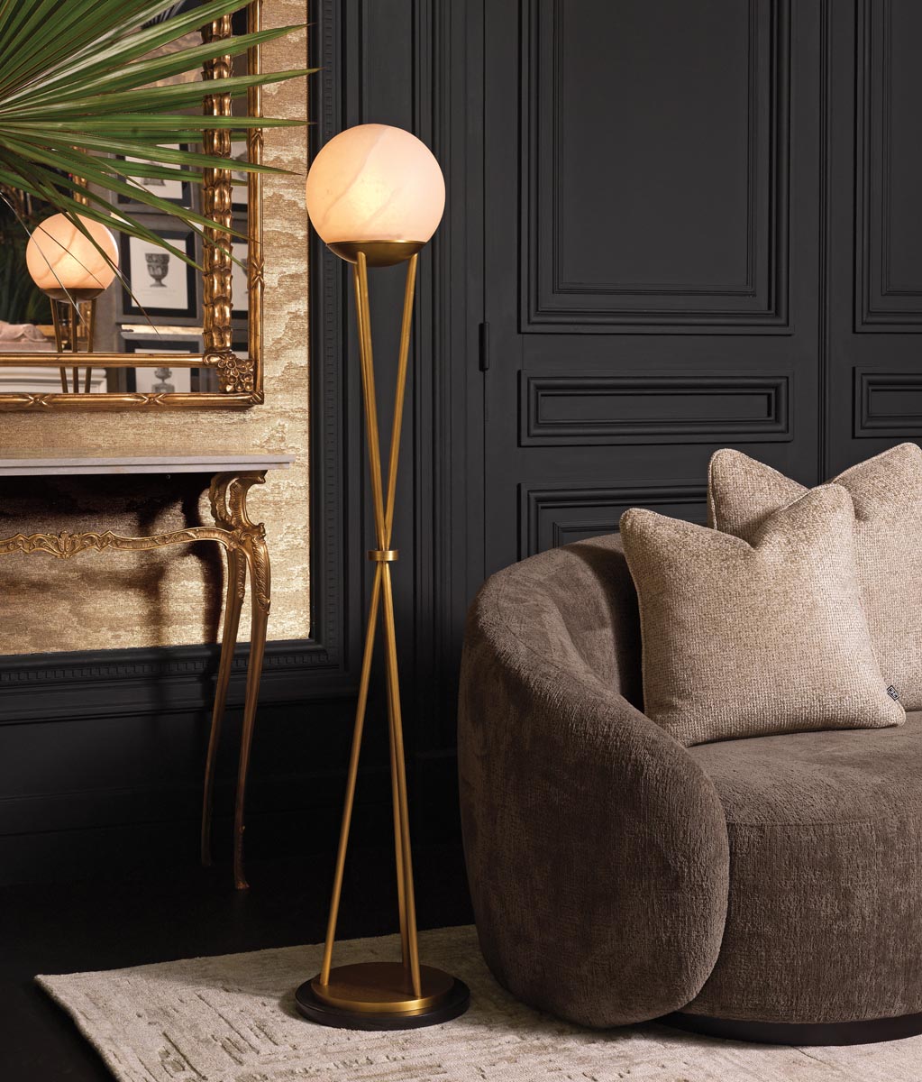 The Izzy floor lamp by Corey Damen Jenkins for Eichholtz is marked by a single alabaster orb on a brass frame